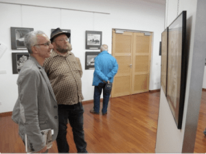 Alberto Peruffo e l'antropologo Giovanni Kezich - direttore del Museo Etnografico delle Genti Trentine - osservano le foto di Maraini.